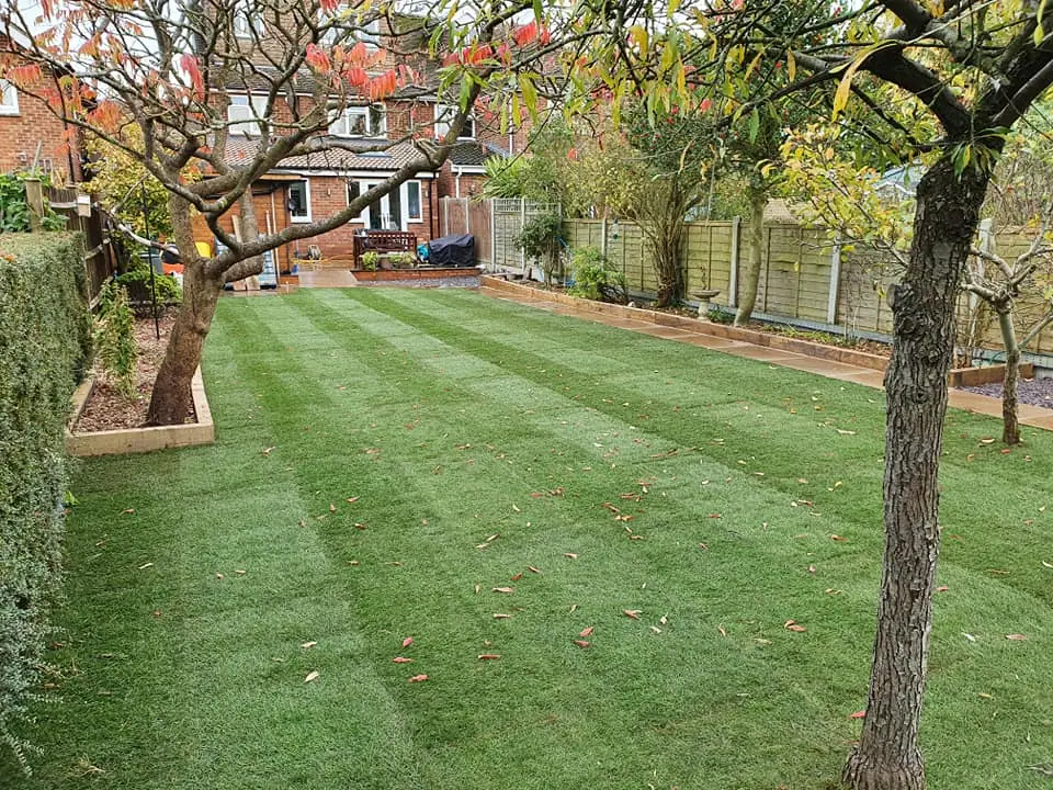 Landscaped garden with lawn, paving and timber fencing